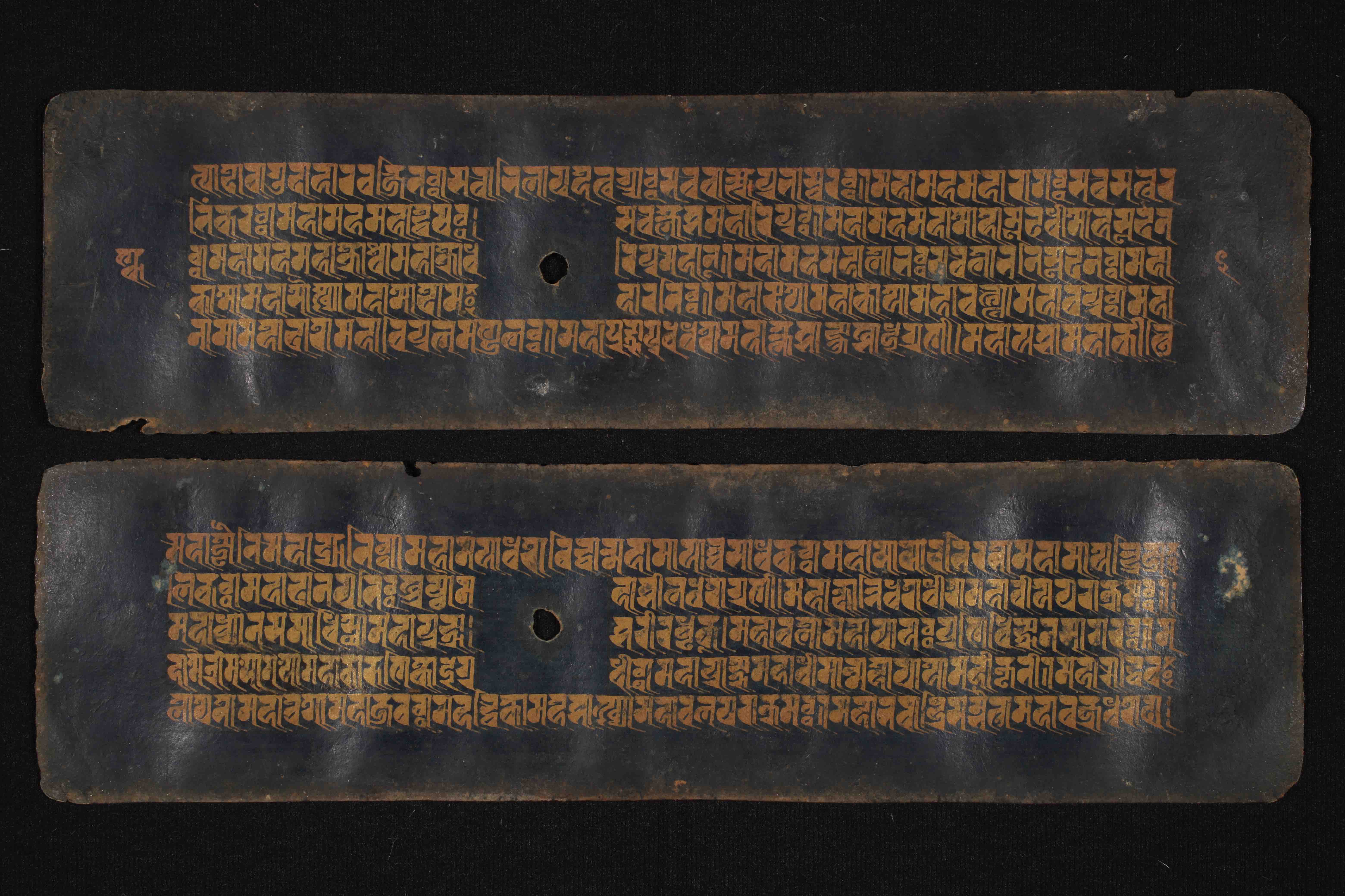 Buddhist manuscript in the Āśā Archives, Kathmandu, Nepal, containing the Nāmasaṃgīti, written with golden ink in Rañjanā script on Nīlapatra (‘black paper’), dating approximately to the 17th c. (DPN 3922)
